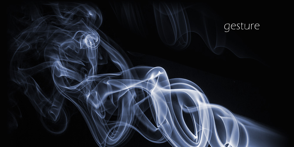 whispy white smoke against a black background with the word geture in the upper  right corner