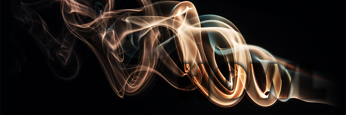 whispy white smoke against a black background